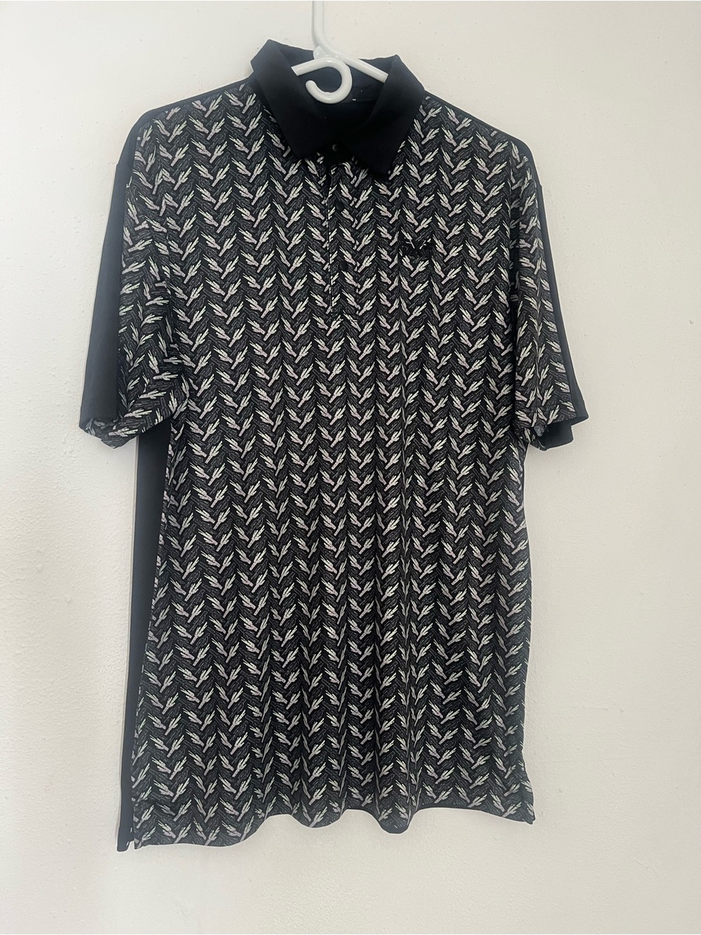 PXG Black Polo with White Geometric Pattern